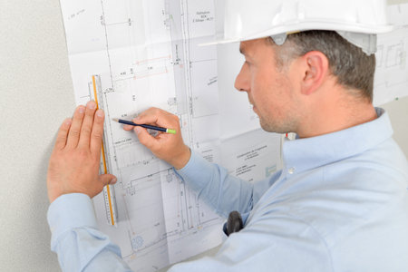 Architect writing on his blue prints