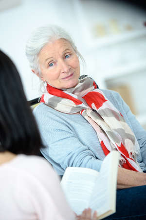 Helping senior woman to readの写真素材