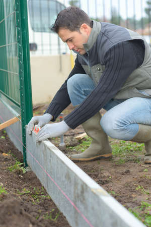 Putting up a fence in the gardenの写真素材