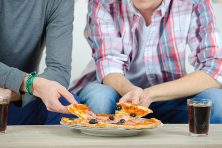 Friends sharing a pizzaの写真素材