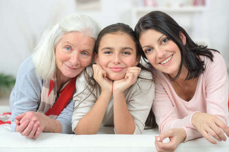 Three generation of women on a sofaの写真素材