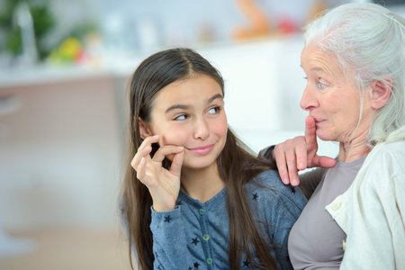 Little girl and grandma whispering secrets