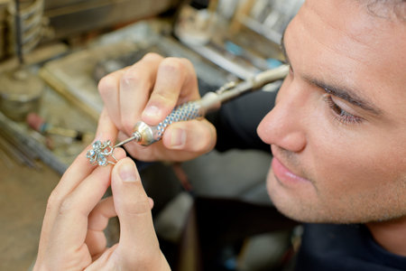 Skilled jeweller repairing a ring