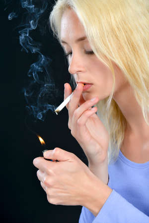 Woman smoking a cigaretteの写真素材