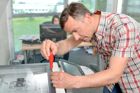 Handyman fixing the office printer