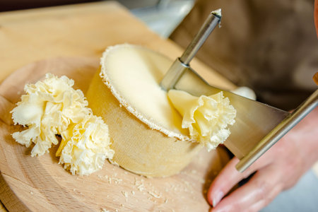 Slicing a wheel of cheese