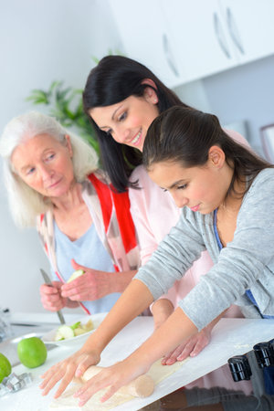 Three generations of women baking together
