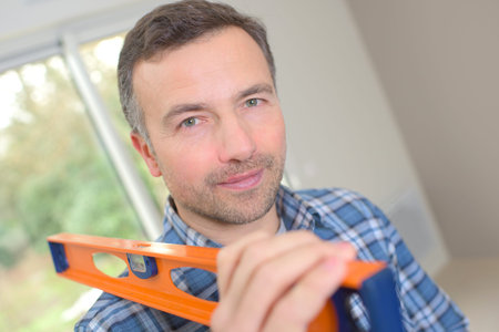 Worker carrying a spirit level