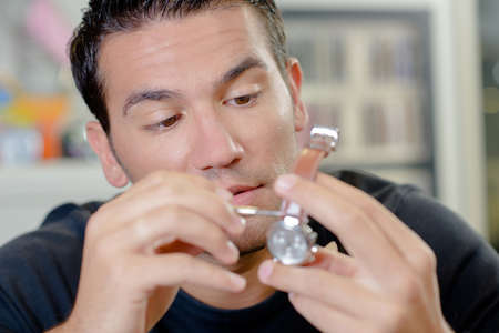 Man repairing watchの写真素材