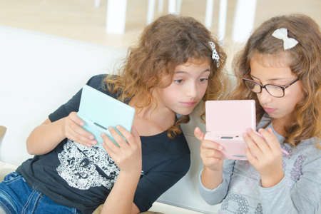 Two sisters playing a video gameの写真素材