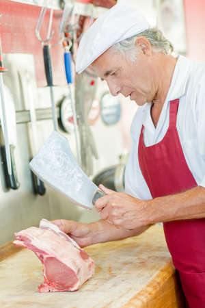 Butcher chopping some porkの写真素材
