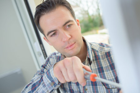 Handyman fitting a new doorの写真素材