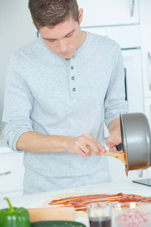 Man preparing a tomato sauceの写真素材