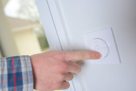 Man controlling the central heating thermostat