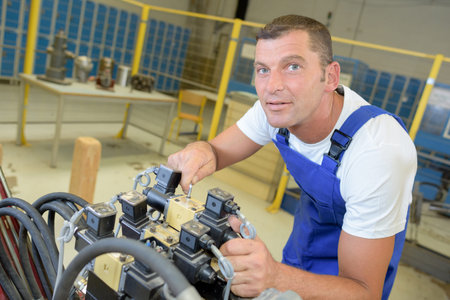 Portrait of man working on machine