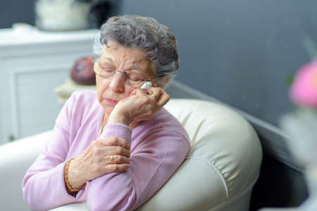 elderly woman on a couchの写真素材