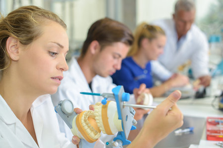 Dental technician clamping impressions togetherの写真素材