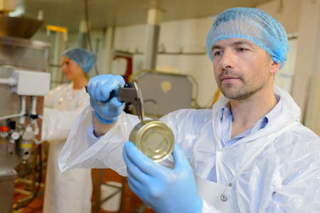 worker measuring tinの写真素材