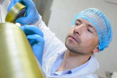 man putting top on canisterの写真素材