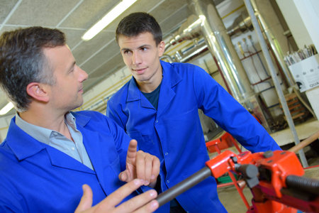 Teacher and student using vice