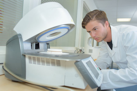Young man using machinery in laboratory