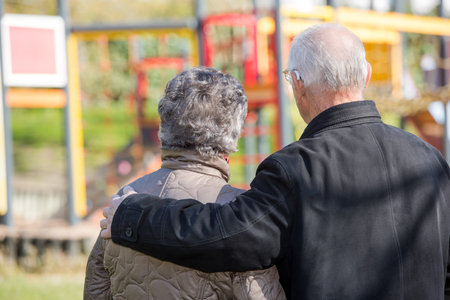 elderly couple looking at a children's parkの写真素材
