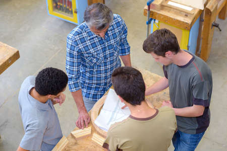 Downward view of men looking at plansの写真素材