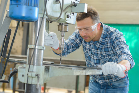 man using a metal driller