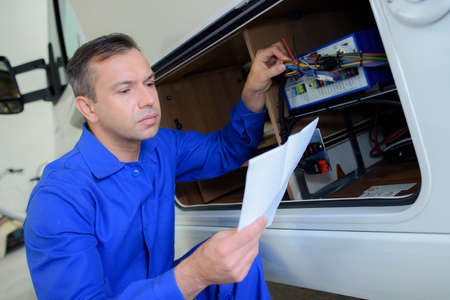 Mechanic checking electrics on campervanの写真素材