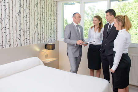 Supervisor talking with hotel personnelの写真素材