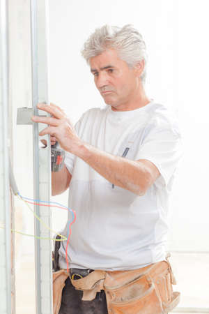 Drilling into a wallの写真素材