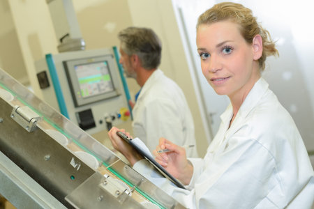 Female technician holding clipboard