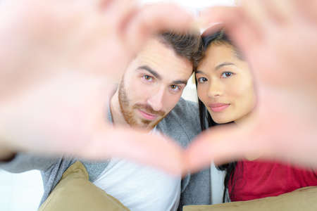 Couple making a heart signの写真素材