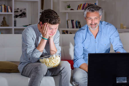 father and son watching tvの写真素材