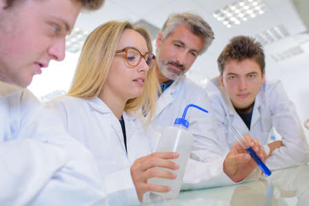 young woman showing an experimentの写真素材