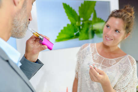 puffing an e-cigaretteの写真素材