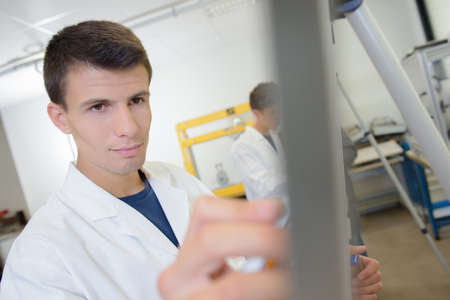 Young man writing on easelの写真素材