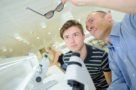 ophtalmologist looking on a pair of glassesの写真素材