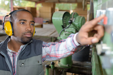 worker adjusting the machine