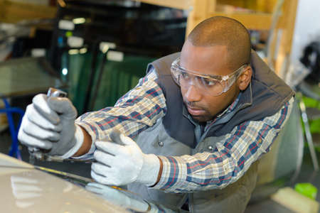 Garage worker fitting windscreenの写真素材