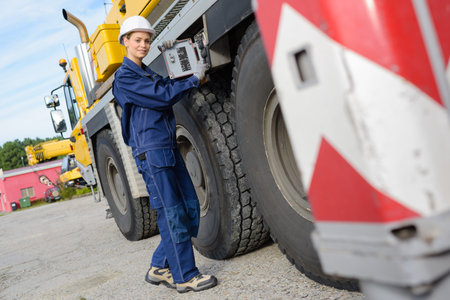 Female worker by side of lorry