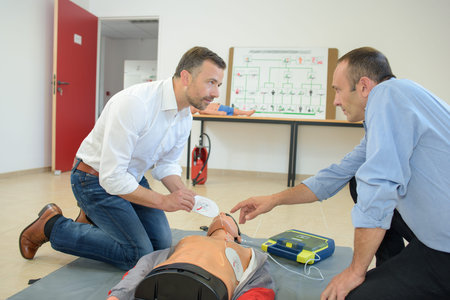 Men doing first aid with dummy
