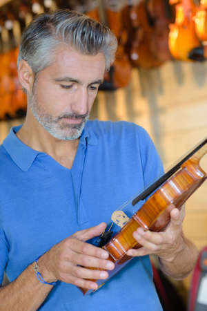 checking the violin componentsの写真素材