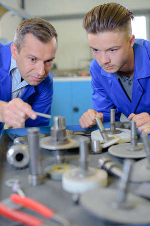 Two male engineers looking at disksの写真素材