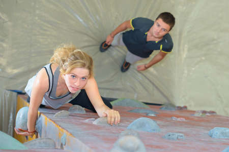Downward view of lady on climbing wallの写真素材
