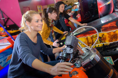 Woman on arcade motorcycleの写真素材