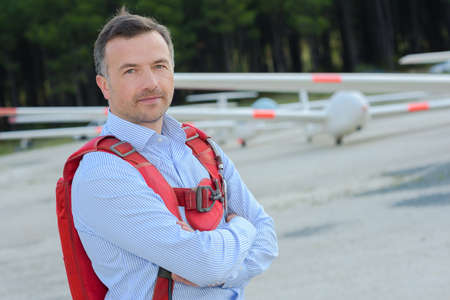 Man at airfield wearing backpackの写真素材