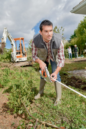 Gardener taking measurements