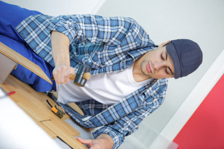 repair building and home concept - male measuring wood flooring