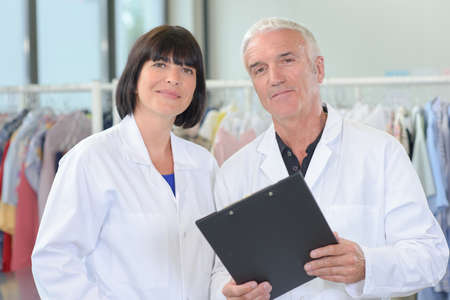 Portrait of couple with clipboardの写真素材